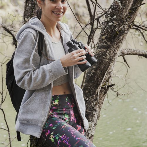smiling-girl-with-binoculars-tree